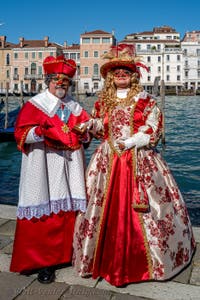 People in costume at the Venice carnival in front of the Madonna della Salute.