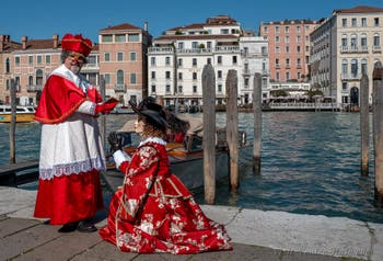 People in costume at the Venice carnival in front of the Madonna della Salute.