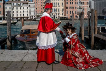 People in costume at the Venice carnival in front of the Madonna della Salute.