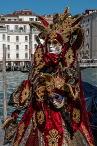 People in costume at the Venice carnival in front of the Madonna della Salute.