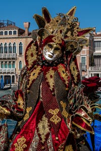 People in costume at the Venice carnival in front of the Madonna della Salute.