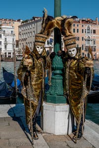 People in costume at the Venice carnival in front of the Madonna della Salute.