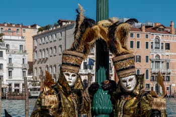 People in costume at the Venice carnival in front of the Madonna della Salute.