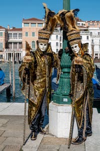 People in costume at the Venice carnival in front of the Madonna della Salute.