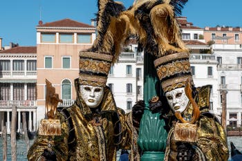 People in costume at the Venice carnival in front of the Madonna della Salute.