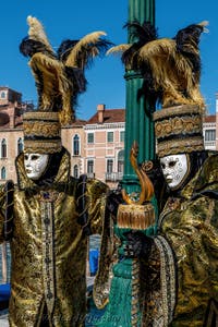 People in costume at the Venice carnival in front of the Madonna della Salute.