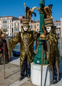 People in costume at the Venice carnival in front of the Madonna della Salute.