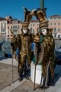 People in costume at the Venice carnival in front of the Madonna della Salute.