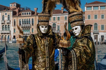 People in costume at the Venice carnival in front of the Madonna della Salute.