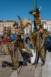 People in costume at the Venice carnival in front of the Madonna della Salute.