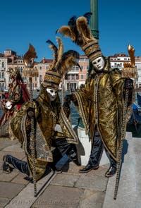 People in costume at the Venice carnival in front of the Madonna della Salute.