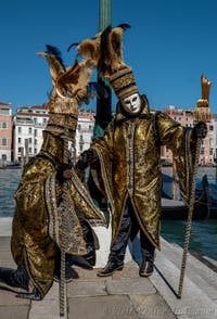 People in costume at the Venice carnival in front of the Madonna della Salute.