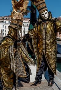 People in costume at the Venice carnival in front of the Madonna della Salute.