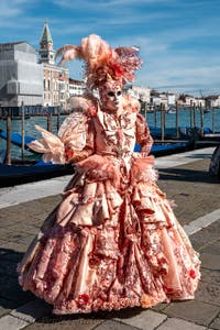 People in costume at the Venice carnival in front of the Madonna della Salute.