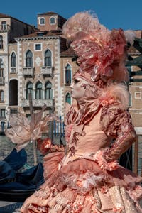 People in costume at the Venice carnival in front of the Madonna della Salute.