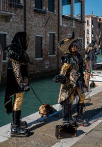 People in costume at the Venice carnival in front of the Madonna della Salute.