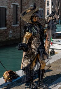 People in costume at the Venice carnival in front of the Madonna della Salute.