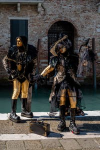 People in costume at the Venice carnival in front of the Madonna della Salute.