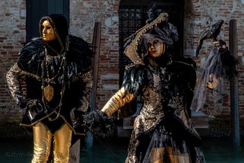 People in costume at the Venice carnival in front of the Madonna della Salute.