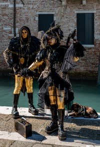 People in costume at the Venice carnival in front of the Madonna della Salute.