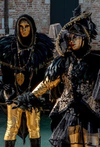 People in costume at the Venice carnival in front of the Madonna della Salute.