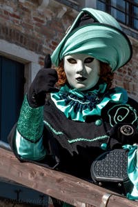 People in costume at the Venice carnival in front of the Madonna della Salute.