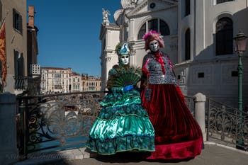 People in costume at the Venice carnival in front of the Madonna della Salute.