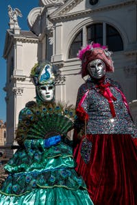 People in costume at the Venice carnival in front of the Madonna della Salute.