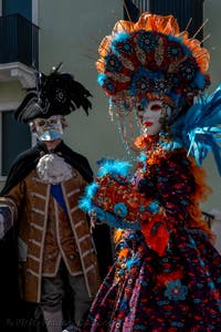 People in costume at the Venice carnival in front of the Madonna della Salute.