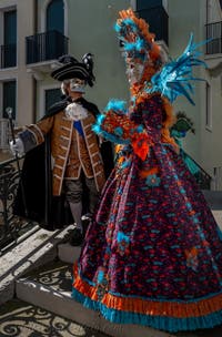 People in costume at the Venice carnival in front of the Madonna della Salute.