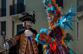 People in costume at the Venice carnival in front of the Madonna della Salute.