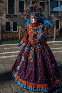 People in costume at the Venice carnival in front of the Madonna della Salute.