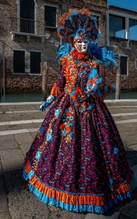 People in costume at the Venice carnival in front of the Madonna della Salute.