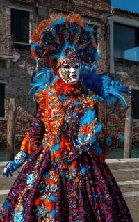 People in costume at the Venice carnival in front of the Madonna della Salute.