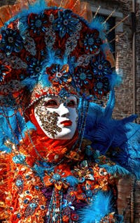 People in costume at the Venice carnival in front of the Madonna della Salute.