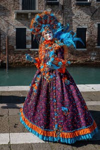 People in costume at the Venice carnival in front of the Madonna della Salute.