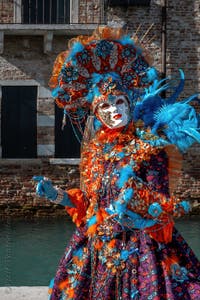 People in costume at the Venice carnival in front of the Madonna della Salute.