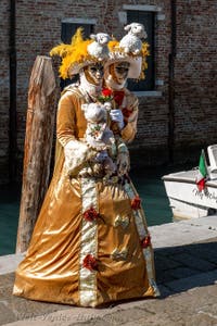 People in costume at the Venice carnival in front of the Madonna della Salute.