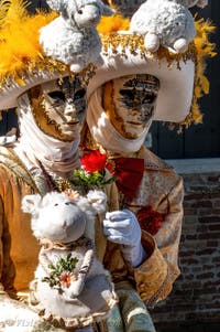 People in costume at the Venice carnival in front of the Madonna della Salute.