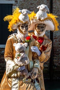 People in costume at the Venice carnival in front of the Madonna della Salute.