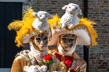 People in costume at the Venice carnival in front of the Madonna della Salute.