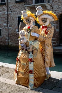 People in costume at the Venice carnival in front of the Madonna della Salute.