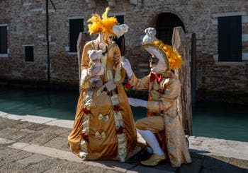 People in costume at the Venice carnival in front of the Madonna della Salute.