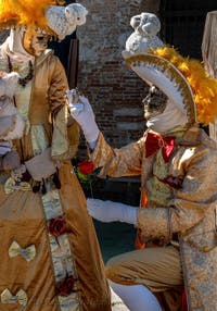 People in costume at the Venice carnival in front of the Madonna della Salute.