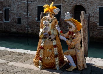 People in costume at the Venice carnival in front of the Madonna della Salute.