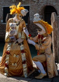 People in costume at the Venice carnival in front of the Madonna della Salute.