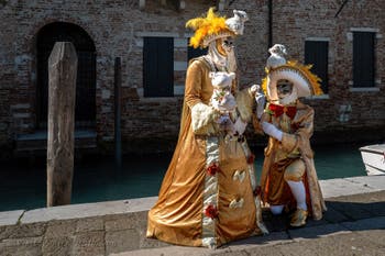 People in costume at the Venice carnival in front of the Madonna della Salute.