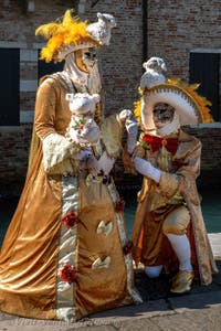 People in costume at the Venice carnival in front of the Madonna della Salute.