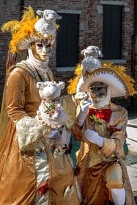 People in costume at the Venice carnival in front of the Madonna della Salute.