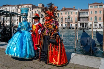 People in costume at the Venice carnival in front of the Madonna della Salute.